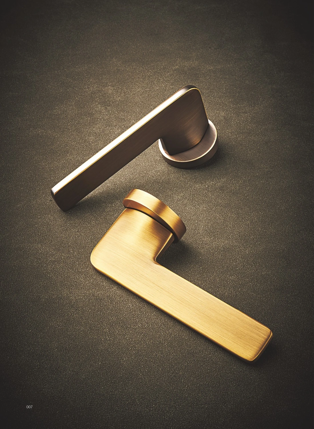 Modern brass door levers in gold and dark finishes