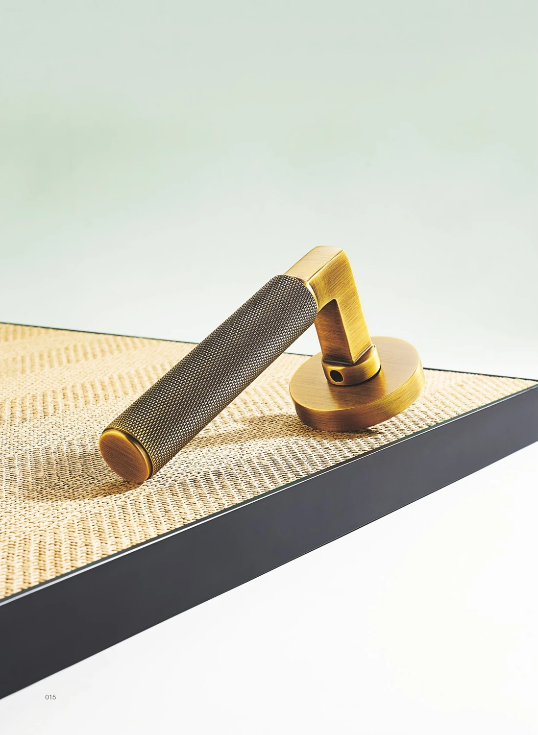 Knurled brass door lever in a light interior setting